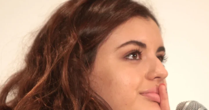 Rebecca Black photographed beside a microphone