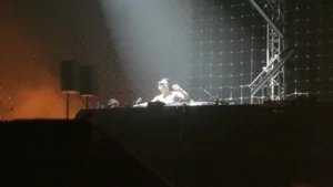 Miss Kittin performing behind decks on a large stage