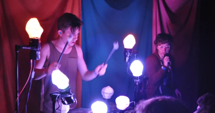 Purity Ring performing live with their illuminated custom stage instrument