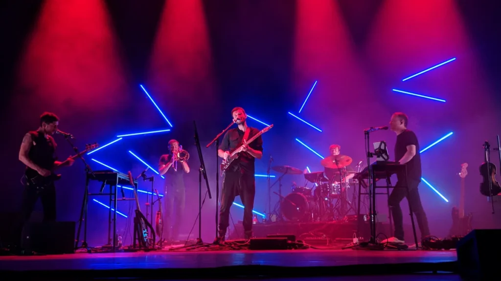 Apparat performing live with a full band under blue and red stage lighting